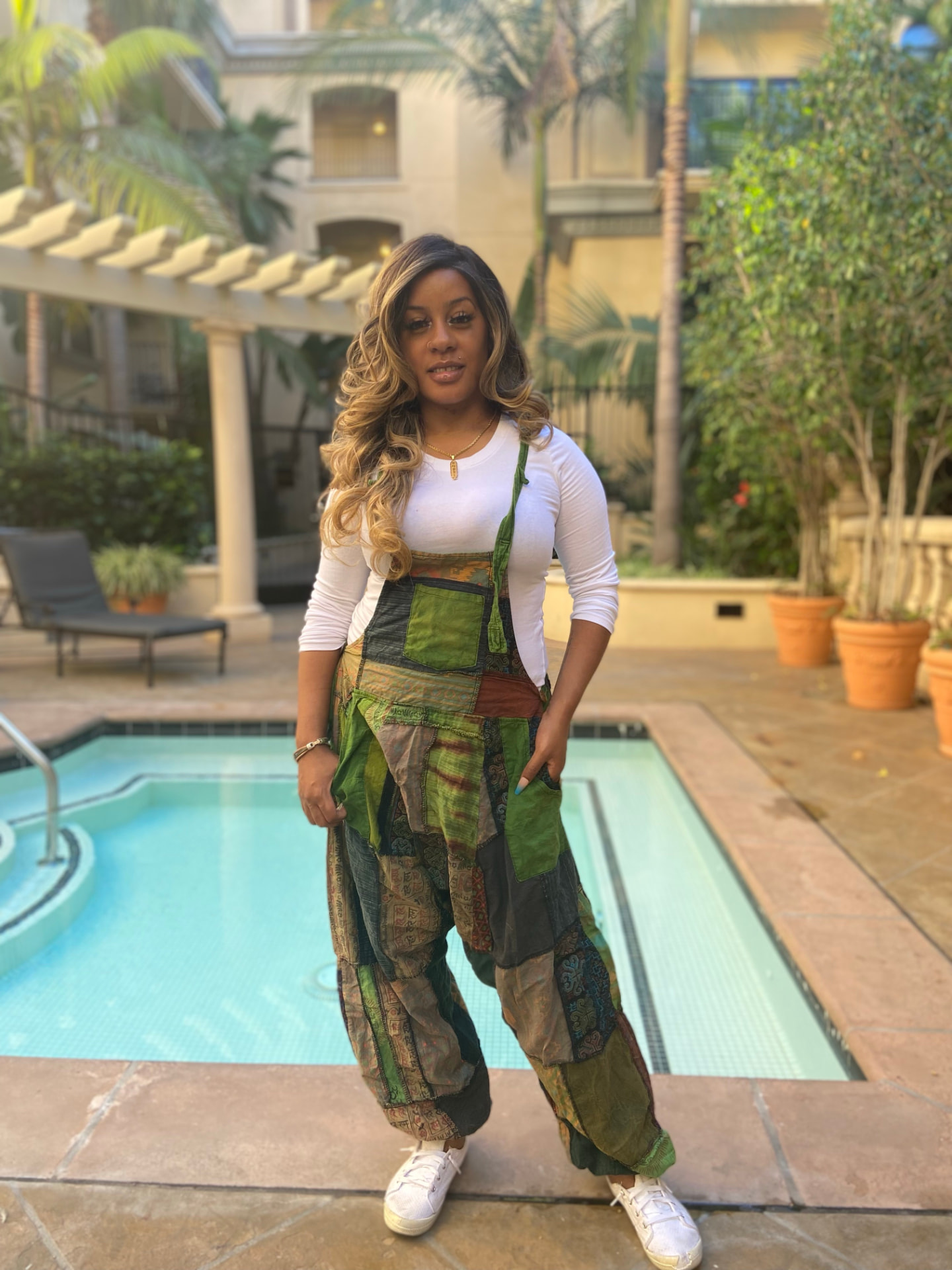 Bobbi Makeda outdoors in green patchwork overalls
